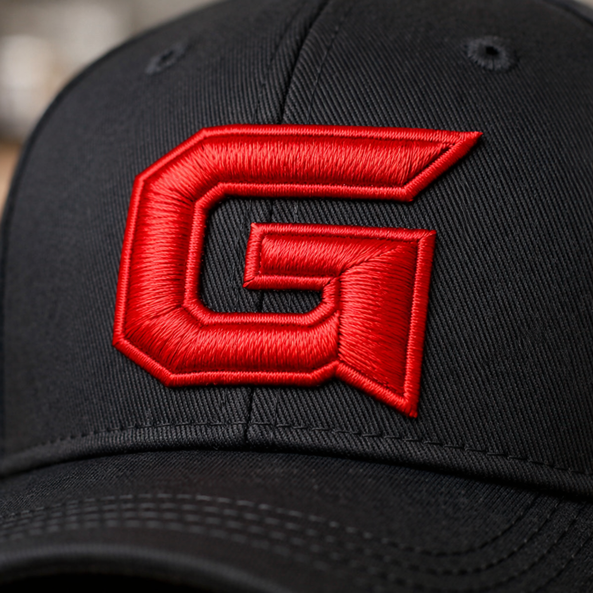 Close-up example of dimensional red embroidery on a black cap